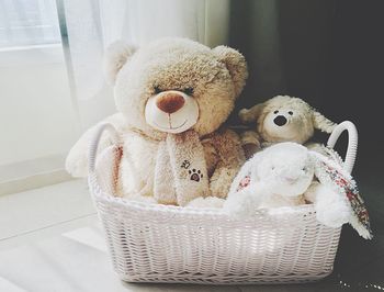 Plush toys in a white basket