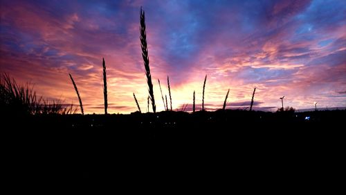 Silhouette landscape against sky during sunset