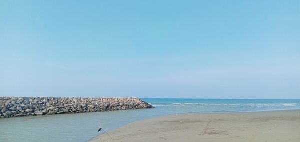 Scenic view of sea against clear blue sky