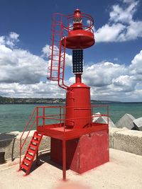 Lifeguard hut on beach against sky