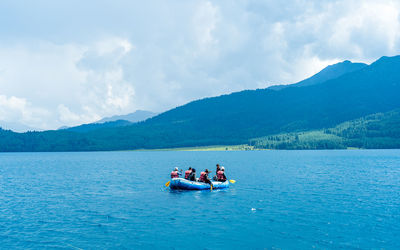 People kayaking in sea