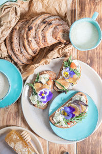 Delicious bruschetta with homemade bread, garnished with fig,soft cheese,pansies