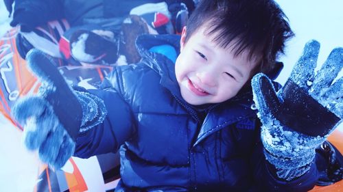 Close-up of smiling boy in snow