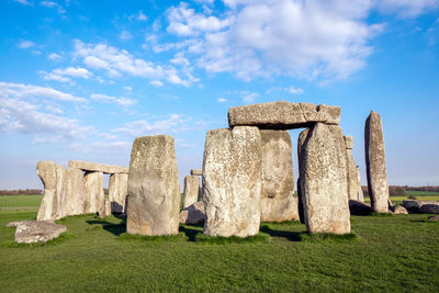 Stone structure on field against sky