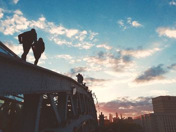 Low angle view of silhouette man against sky during sunset