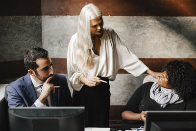 Multiracial lawyers discussing during meeting at office