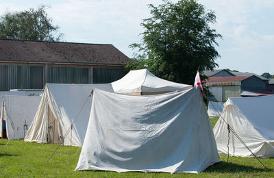 Clothes drying on clothesline by building against sky