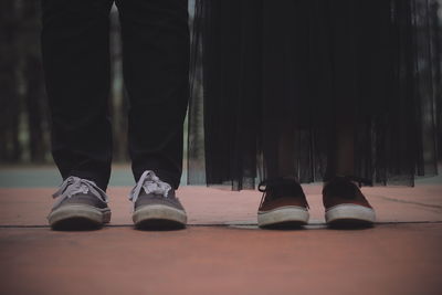 Low section of couple standing on floor