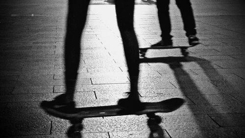 Low section of person shadow on tiled floor