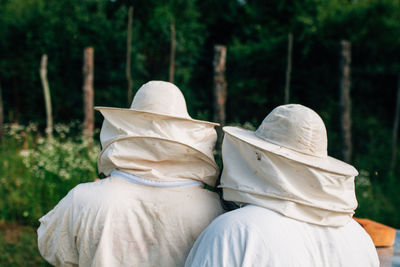 Rear view of people sitting in forest