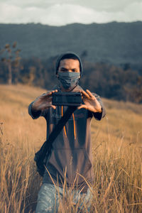 Portrait of man standing on field