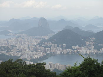 High angle view of cityscape and mountains against sky