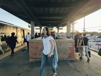 Women walking on bridge in city