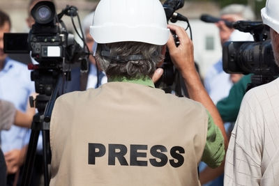 Rear view of man photographing