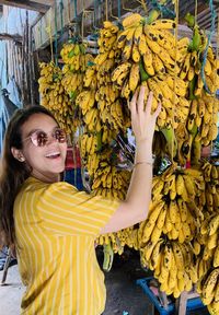 Portrait of a smiling young woman with bananas bananas and more bananas 