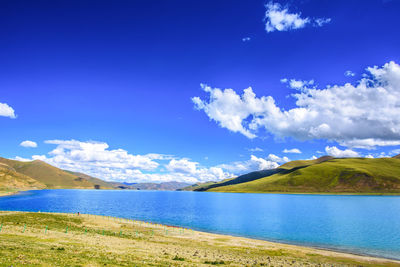 Scenic view of lake against blue sky