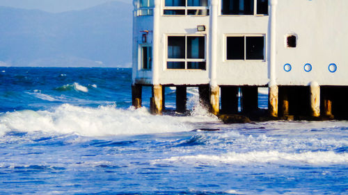 Built structure in sea against sky