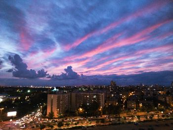 High angle view of illuminated buildings against sky at sunset