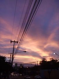 Low angle view of electricity pylon against sky