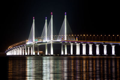 Penang bridge over selatan strait against clear sky at night