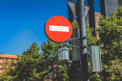 Low angle view of road sign against trees