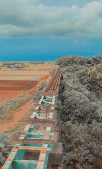 High angle view of road amidst land against sky