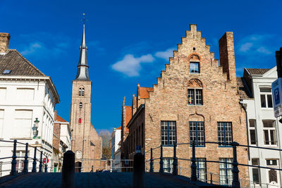 Buildings in city against sky