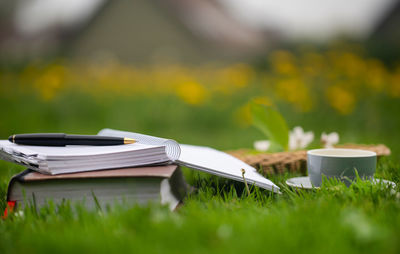 Close-up of book on field