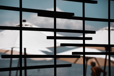 Close-up of glass window against sky