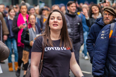 Young couple looking at group of people