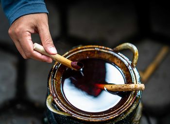 Close-up of man holding cigarette