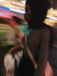 Blurred motion of people walking on subway platform