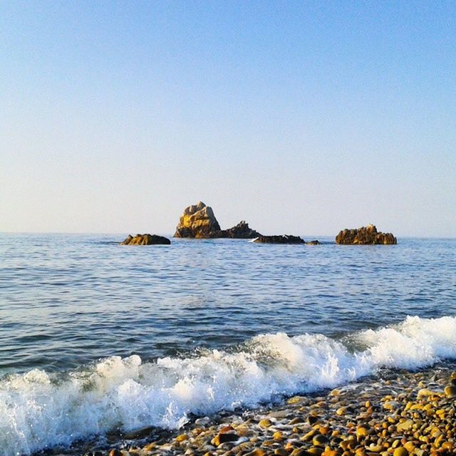 sea, water, clear sky, copy space, scenics, horizon over water, beauty in nature, tranquil scene, rock - object, tranquility, nature, wave, rock formation, blue, beach, shore, surf, idyllic, rock, rippled