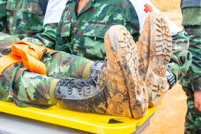 Army soldiers providing first aid to man on stretcher