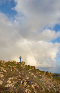 Man standing on mountain against sky