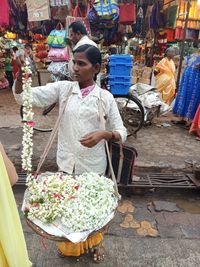 Woman standing at market stall