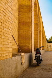 Man riding motorcycle on street against building