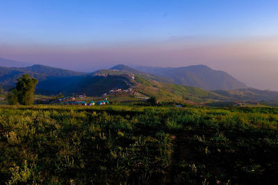 Scenic view of landscape and mountains against sky