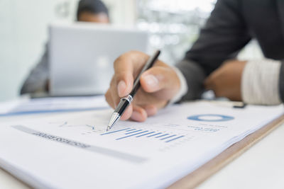 Close-up of man with text on table