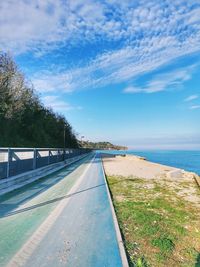 Road by sea against sky