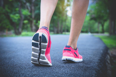 Low section of man running on road