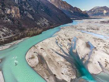 Scenic view of lake by mountains during winter