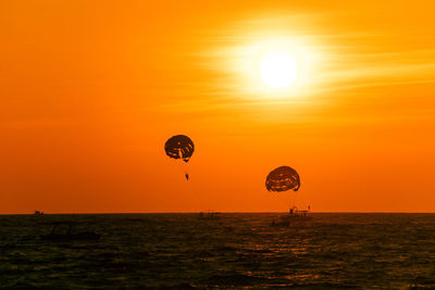 Scenic view of sea against orange sky