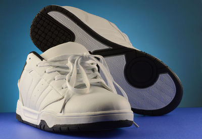 Close-up of shoes against blue background