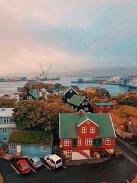 High angle view of townscape by sea against sky