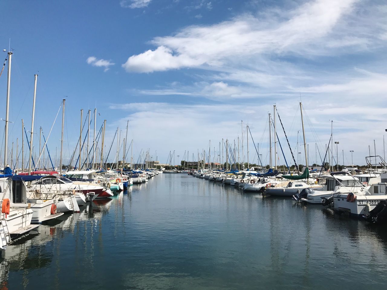 nautical vessel, moored, harbor, sky, mode of transport, reflection, cloud - sky, water, transportation, no people, mast, outdoors, large group of objects, sailboat, tranquility, travel destinations, day, nature, sea, yacht