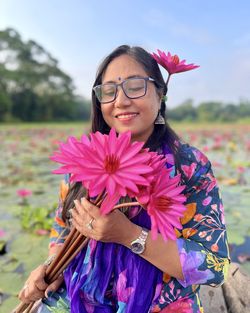 Portrait of a smiling woman with water lilies