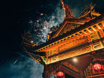 Low angle view of illuminated building at night