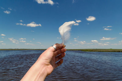 Close up feather in hand concept photo