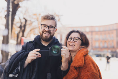 Portrait of young woman taking selfie with smart phone